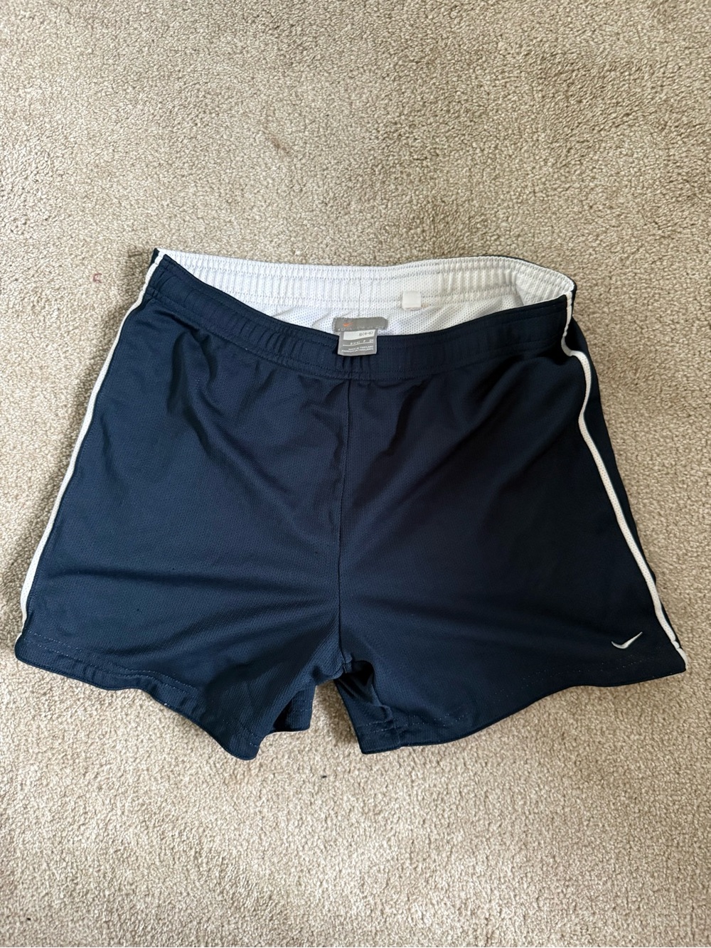 Nike Navy Shorts with White Waistband and Small Orange Swoosh
